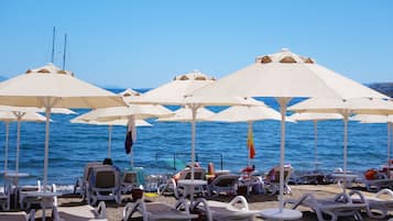 On the beach, sun loungers, beach umbrellas, beach towels