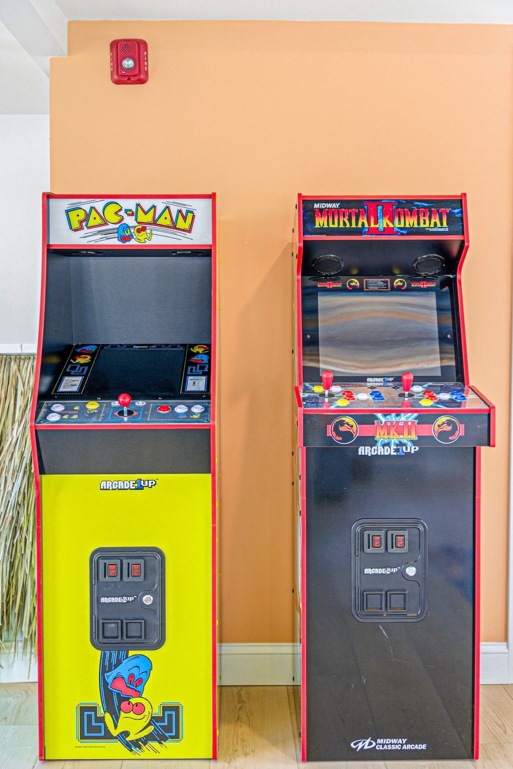 Two arcade machines, one for Pac-Man and one for Mortal Kombat, both branded with Arcade-Up.