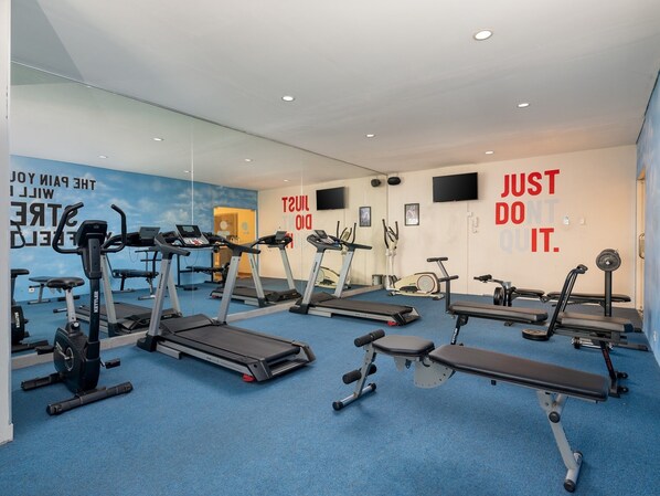 A gym with treadmills, stationary bikes, and weight machines. - Aston Solo (Surakarta)