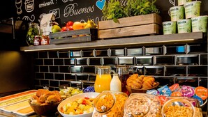A breakfast buffet with various food items and beverages. - Motel One London-Tower Hill (London)