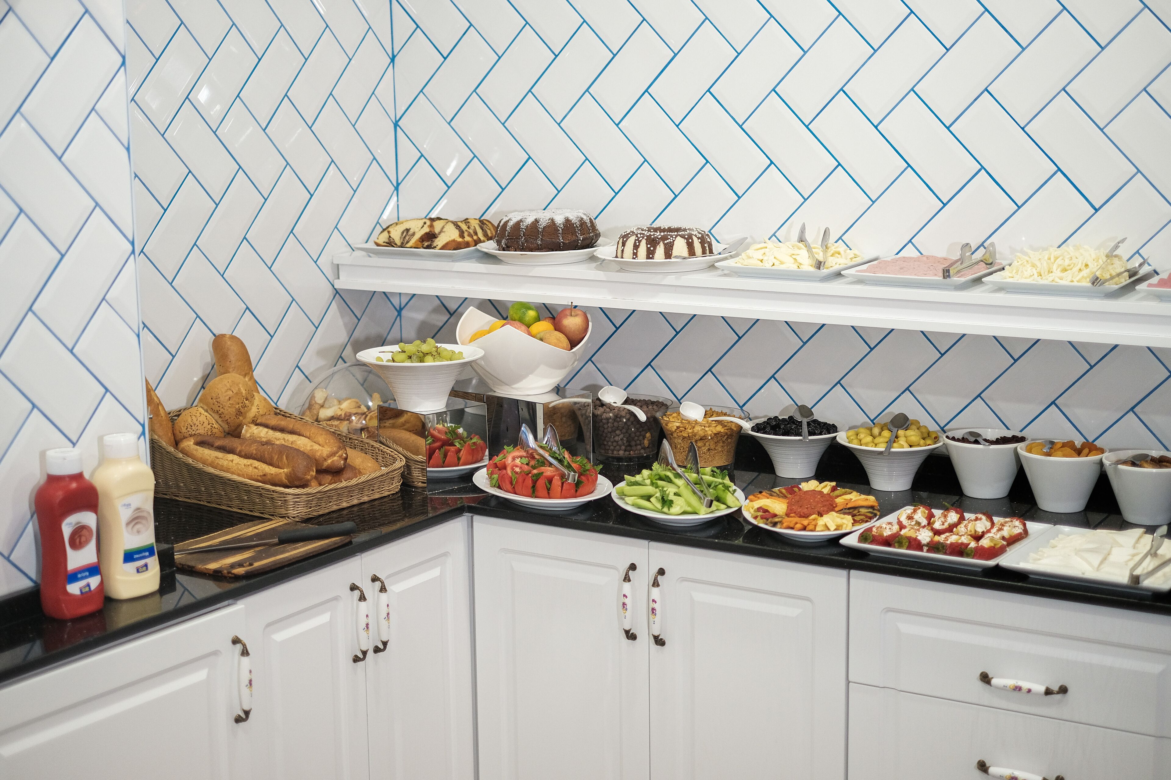A buffet with various food items and condiments.