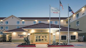 TownePlace Suites Marriott at 2732 with a tiled roof, flagpoles, and a well-lit entrance. - TownePlace Suites by Marriott Seguin (Seguin)
