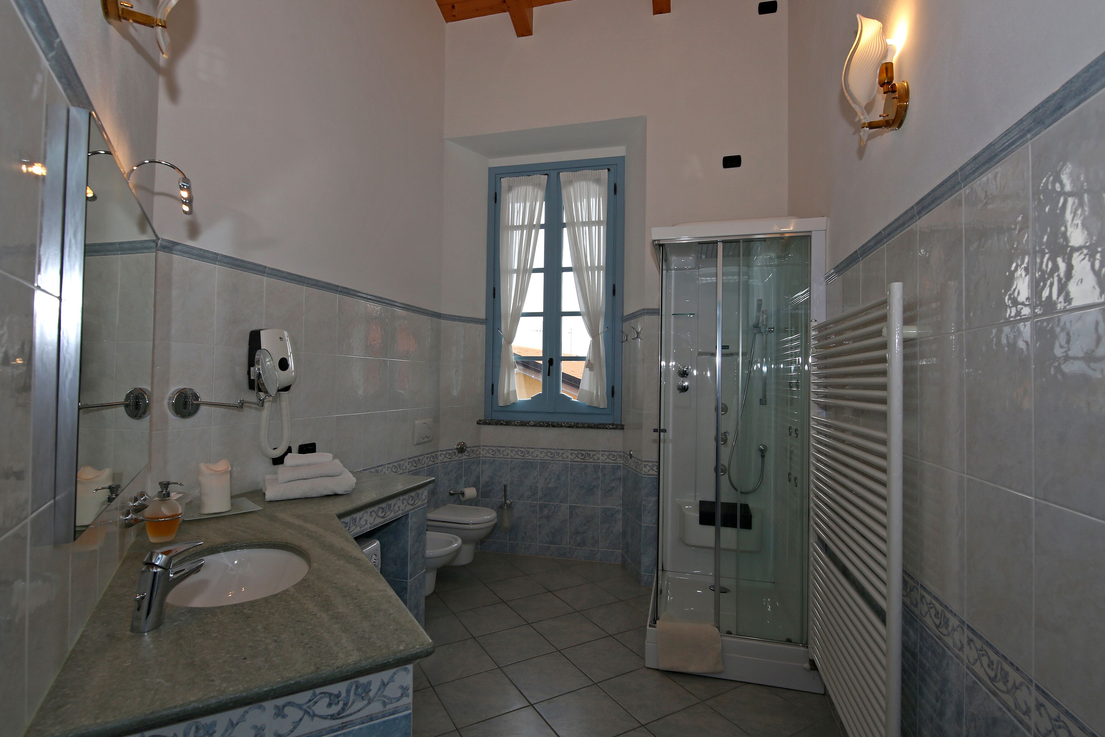 A bathroom with a sink, toilet, and shower.