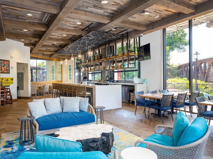 A spacious interior with a large dining area, a bar, and a kitchen.