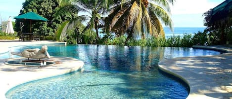 Una piscina al aire libre, tumbonas