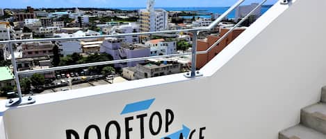 A view from the rooftop terrace of a building with a sign reading "ROOFTOP TERRACE".