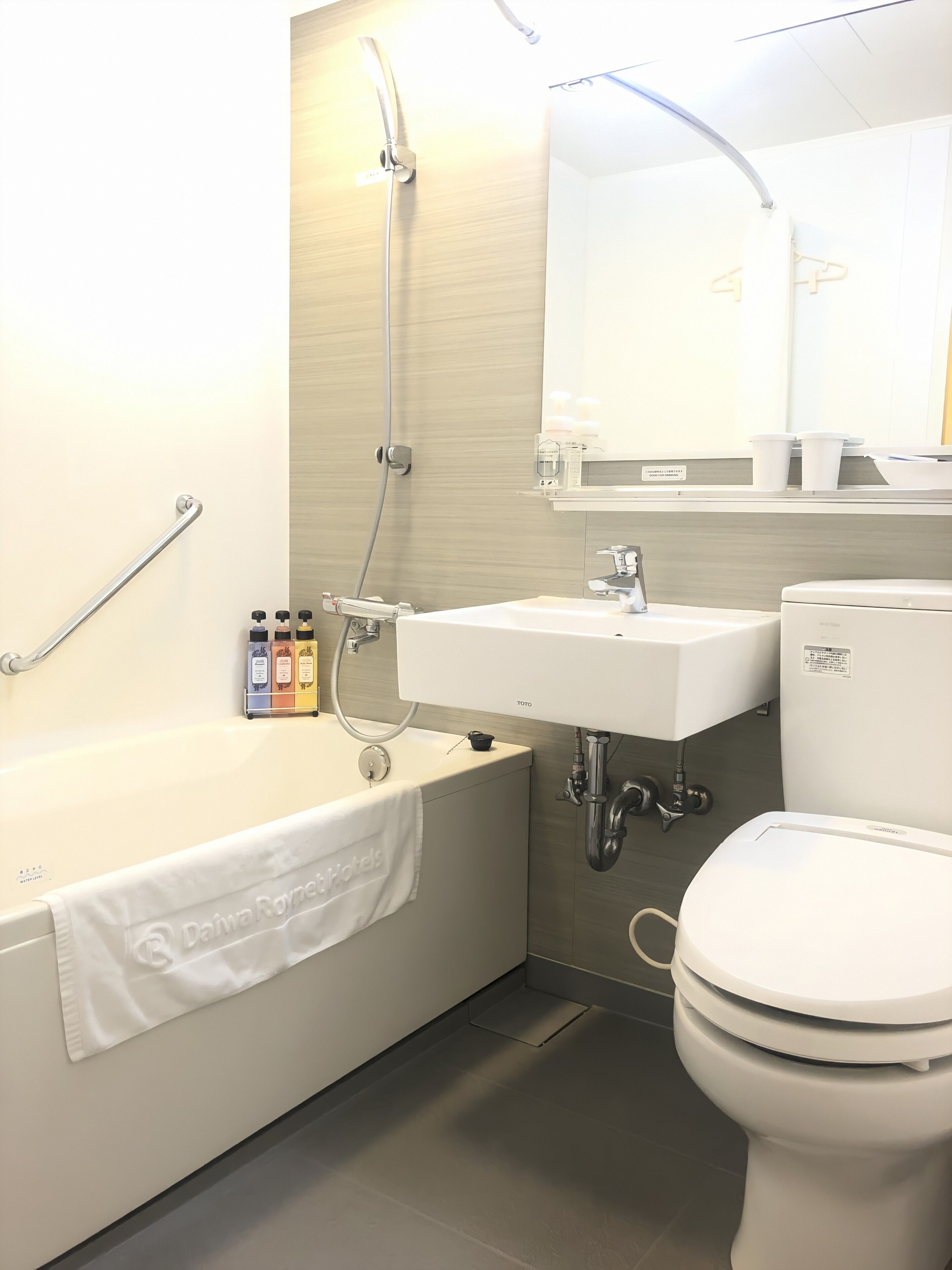 A modern bathroom with a bathtub, a sink, a toilet, and a shower.