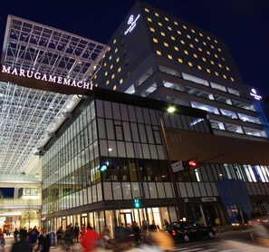 A modern hotel with a glass facade and a prominent sign for Marugame Hotel. - Daiwa Roynet Hotel Takamatsu (Takamatsu)