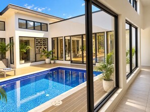 A modern house with a swimming pool, large windows, and outdoor furniture. - Sapphire Bay Fiji (Lautoka)