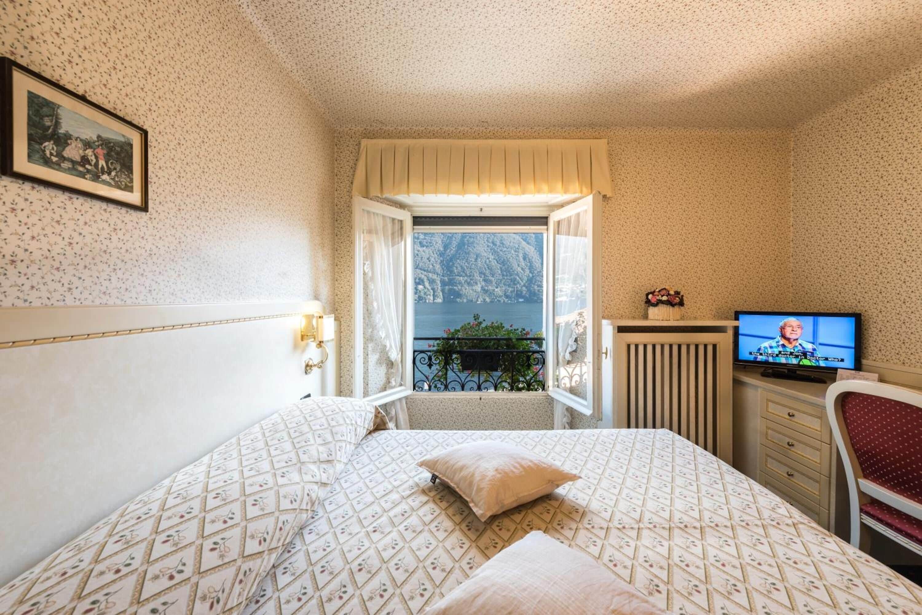 double room, balcony, lake view | minibar, in-room safe, desk, laptop workspace