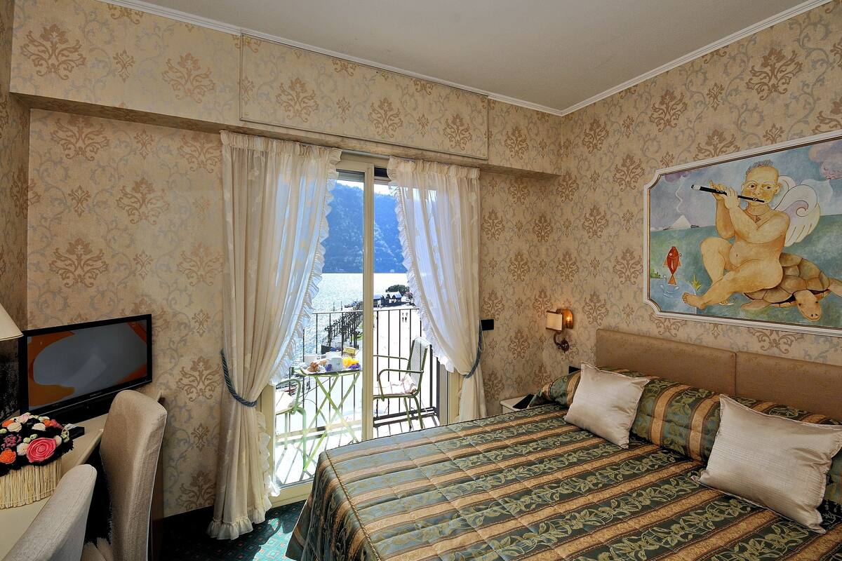 double room, balcony, lake view | minibar, in-room safe, desk, laptop workspace