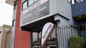 A hotel reception area with a sign indicating 'RECEPTION' and 'O'Shea's Royal Hotel'.