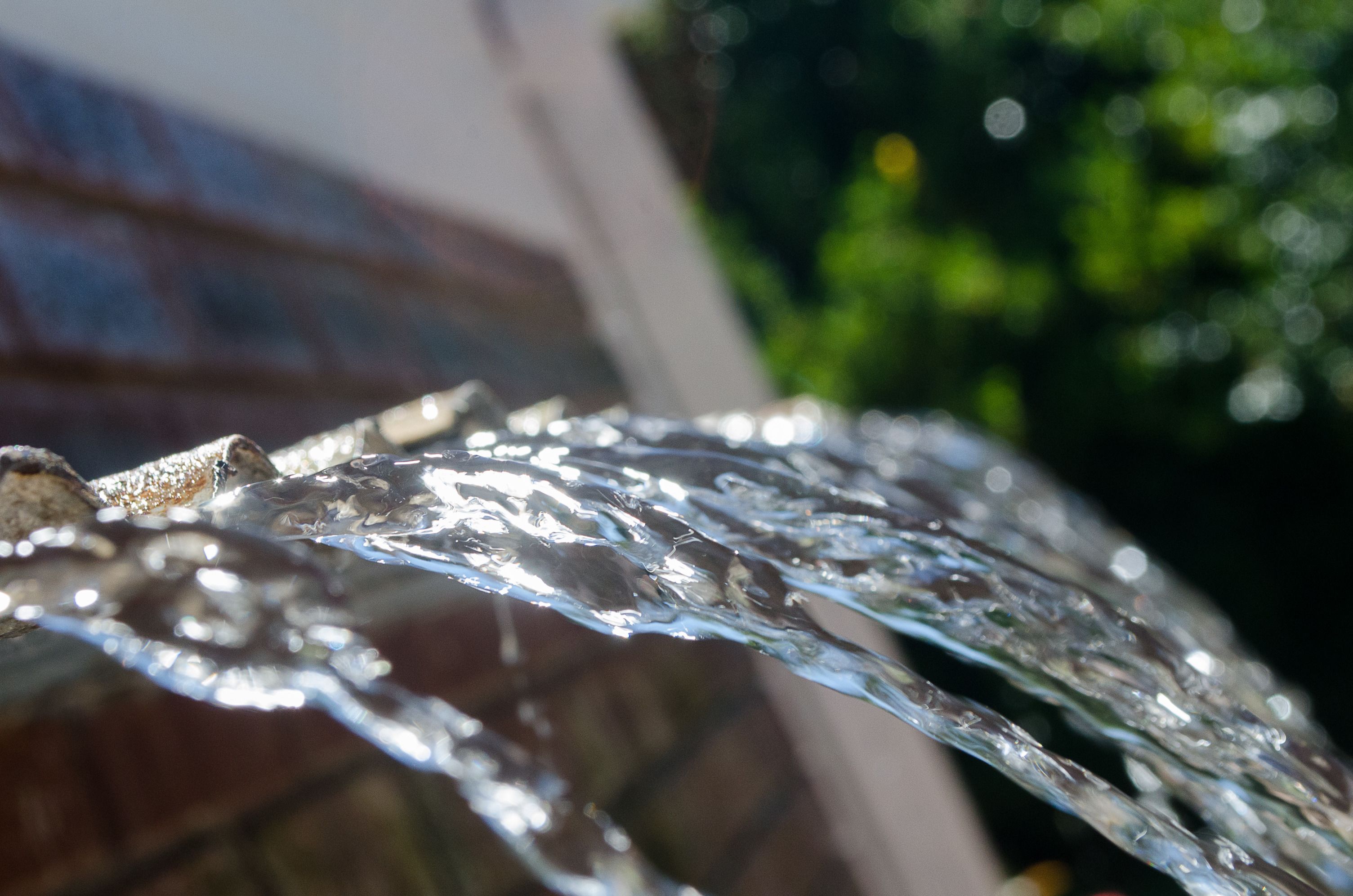 A close-up of water flowing over a textured surface.