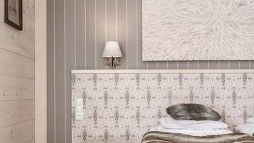 A bedroom with a bed, a bedside table, a lamp, and a decorative wall panel.