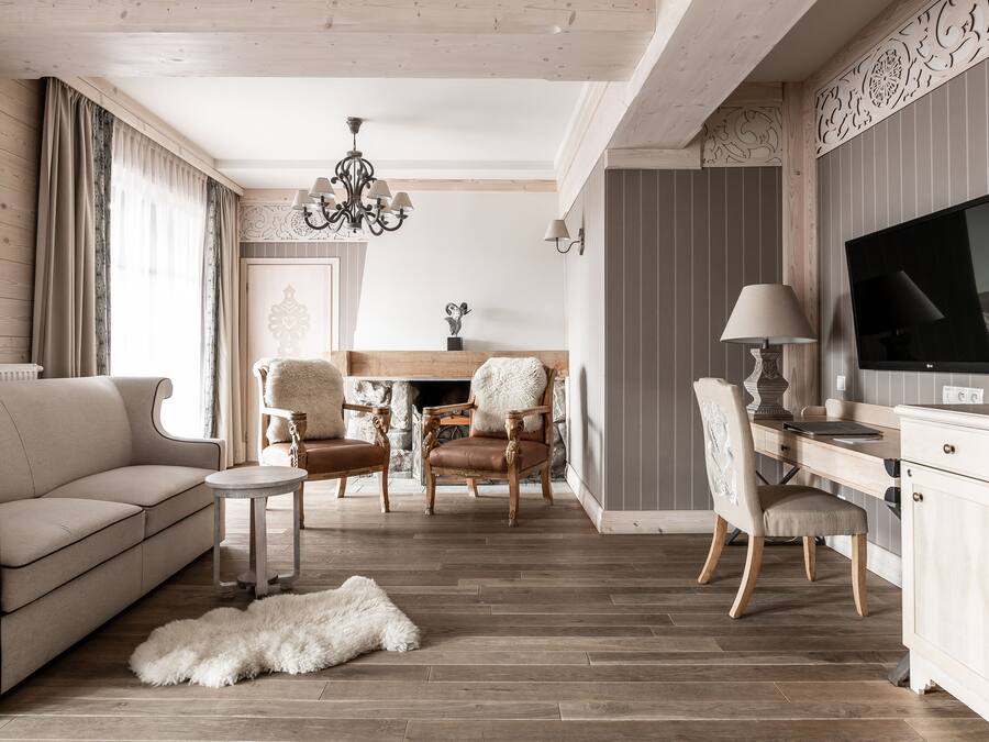 A living room with a sofa, chairs, a TV, and a fireplace.