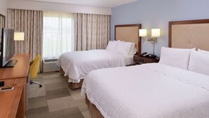 A hotel room with two beds, a desk, a chair, a TV, and a window with curtains. - Hampton Inn & Suites by Hilton Lonoke (Lonoke)