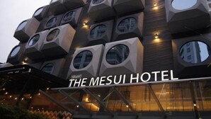 The Mesui Hotel with a unique geometric facade featuring multiple circular windows and a modern design. - The Mesui Hotel (Kuala Lumpur)
