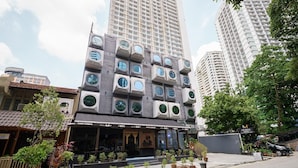 A hotel with a unique facade featuring circular windows and a traditional entrance. - The Mesui Hotel (Kuala Lumpur)