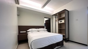 A modern hotel room with a bed, bedside table, wardrobe, and built-in lighting. - The Mesui Hotel (Kuala Lumpur)