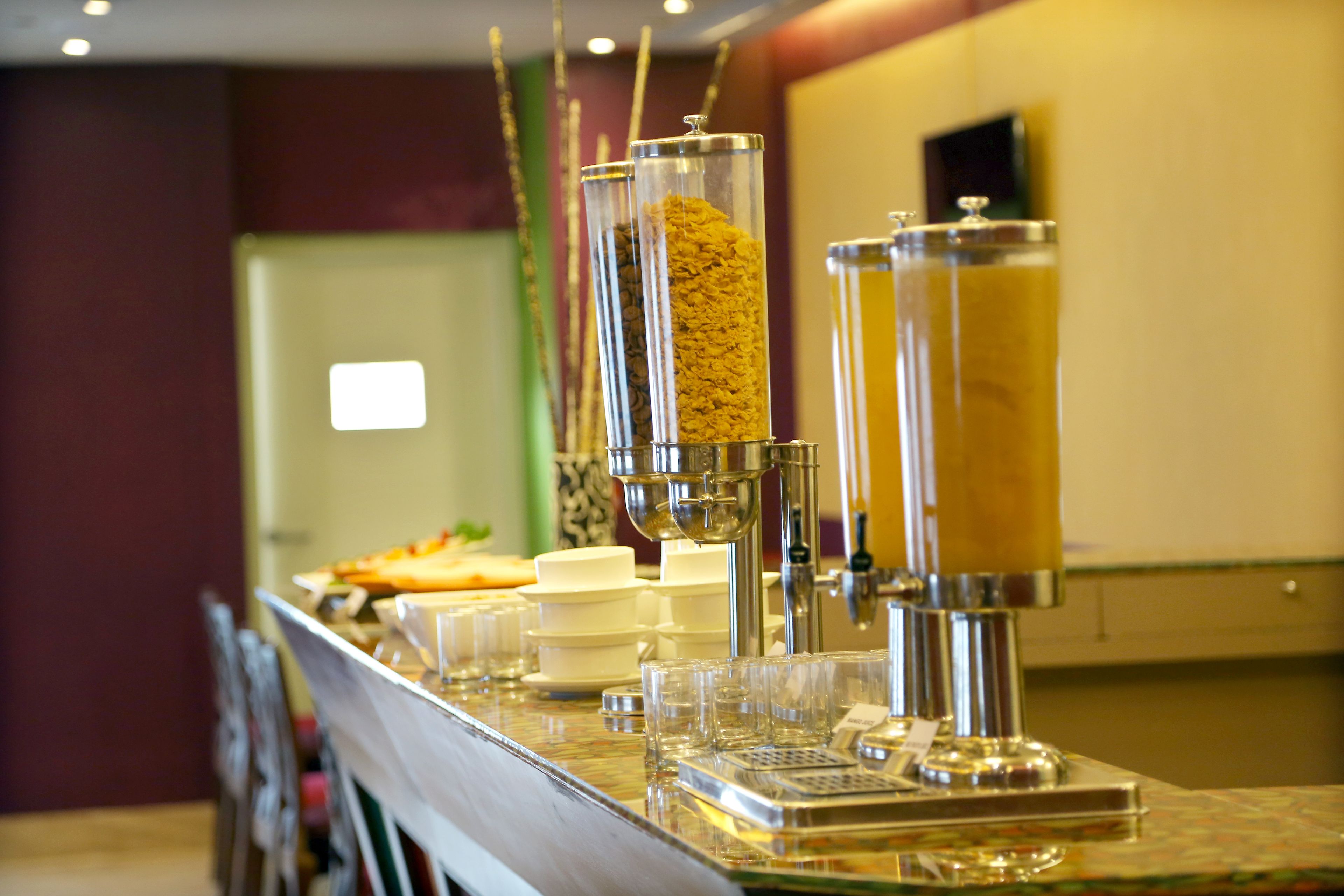A buffet setup with various food dispensers and serving dishes.