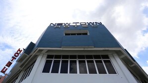 A hotel named "New Town Hotel" with a modern architectural design.