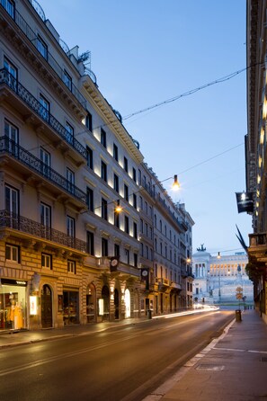 Vista d'un carrer d'un edifici històric amb diversos pisos, finestres grans i balcons.