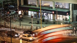 A building with a sign reading "Welcome to Watford Junction."