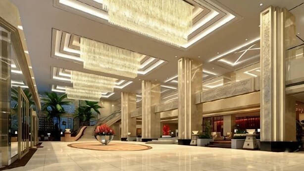 A spacious lobby with high ceilings, chandeliers, and a central floral arrangement. - Petroleum Hotel (Yulin)