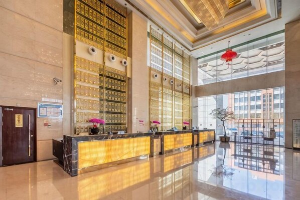A spacious lobby with a reception desk, large windows, and a high ceiling. - Petroleum Hotel (Yulin)