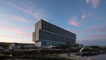 A modern hotel with a flat roof and a sign reading "nest" on top.