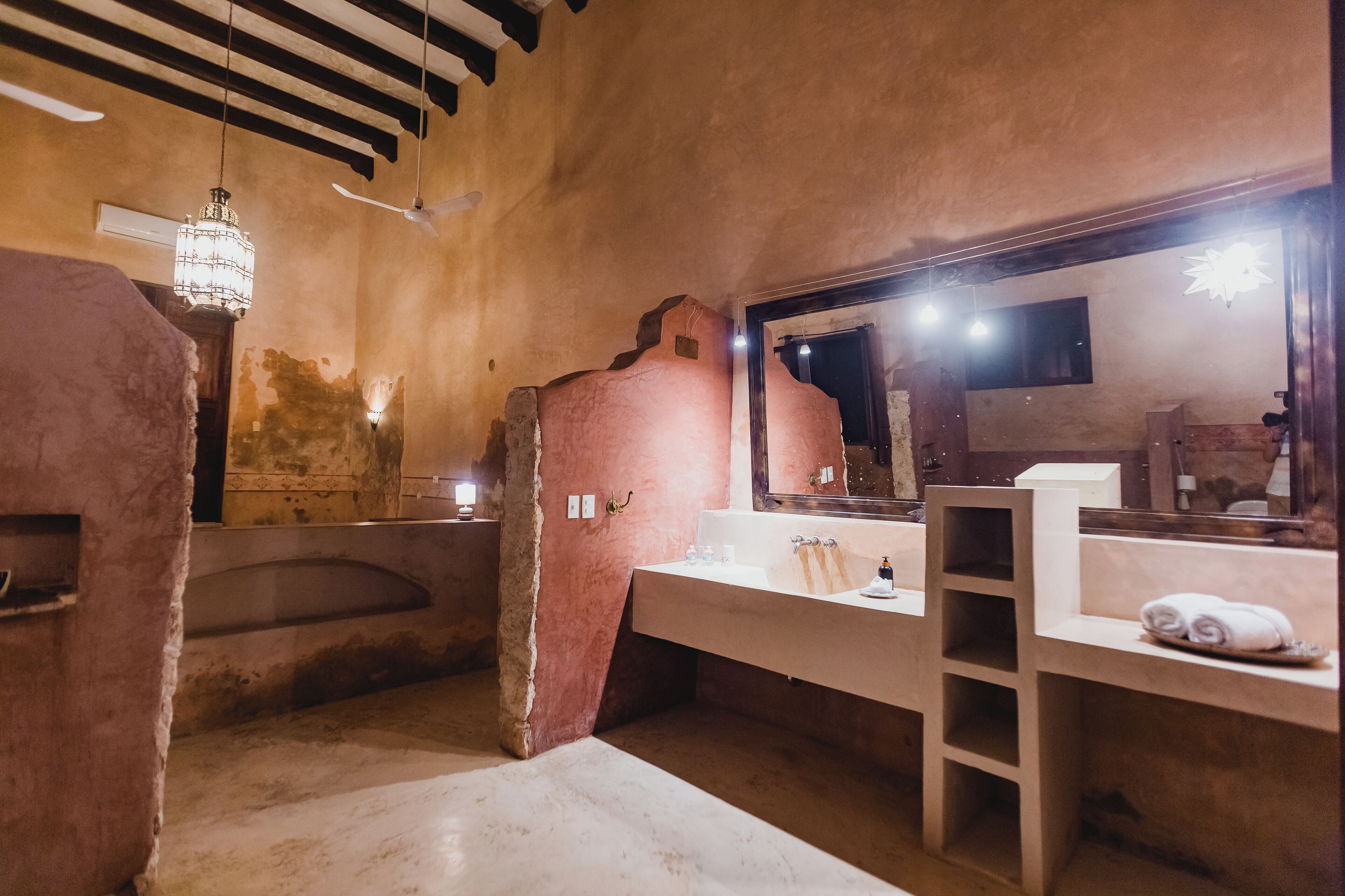 A bathroom with a bathtub, a sink, and a mirror.