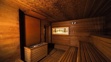 A sauna with wooden benches and a bench with a sink.