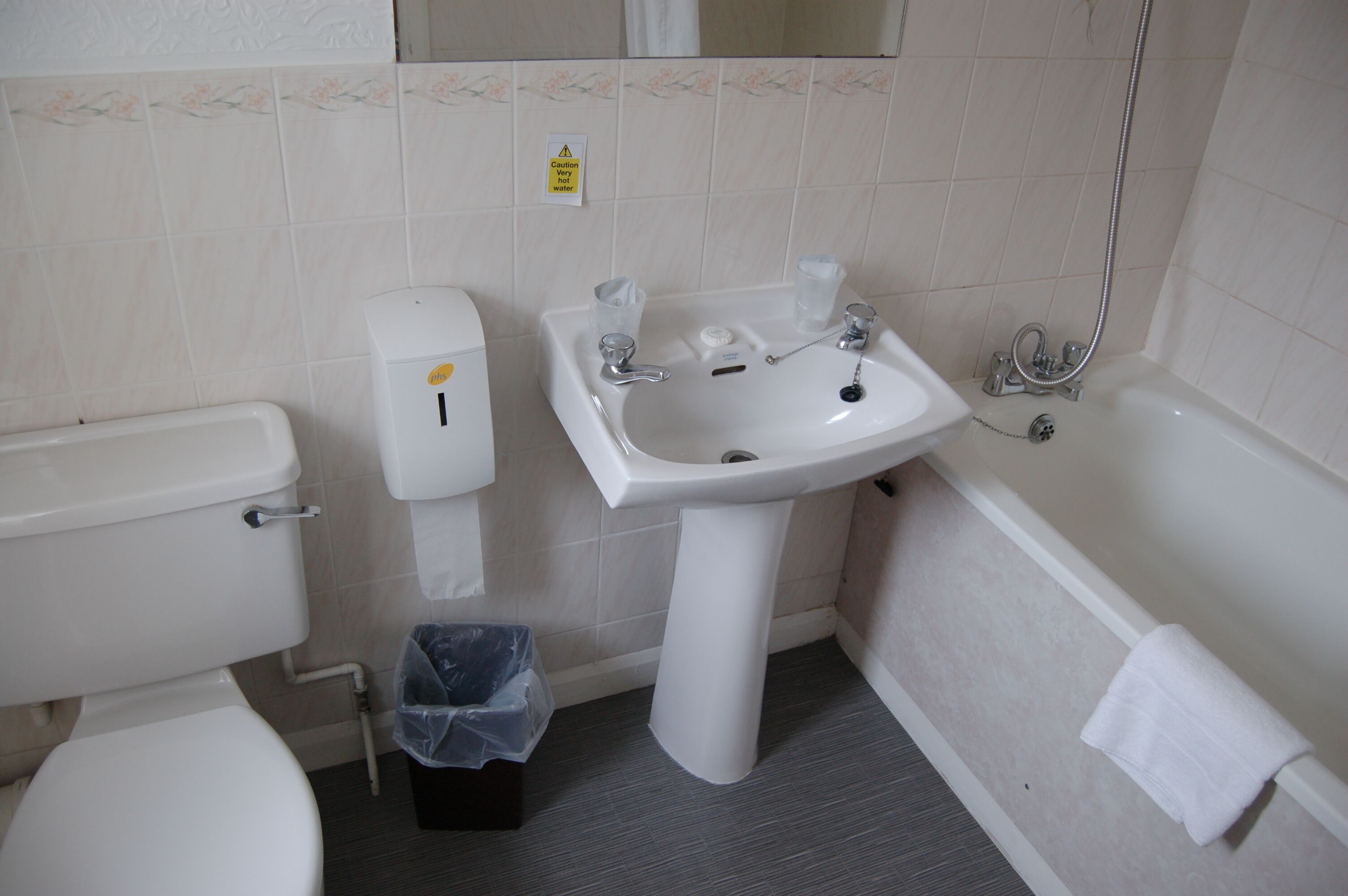 A bathroom with a toilet, sink, and bathtub.