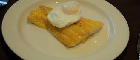 A plate with a fried egg on top of a piece of toast.