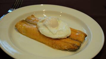 A plate with a piece of fish and a poached egg.