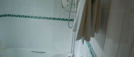 A bathroom with a bathtub, a sink, and a shower.