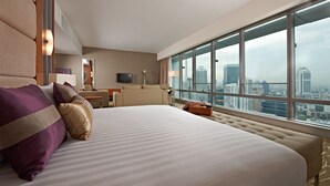 A hotel room with a large bed, a desk, a chair, and a television. The room has a large window with a city view. - Premiera Hotel Kuala Lumpur (Kuala Lumpur)
