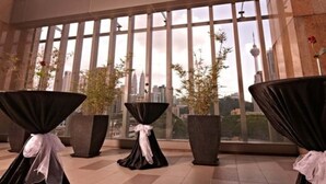 A modern hotel lobby with large windows offering a city view, including a prominent tower. - Premiera Hotel Kuala Lumpur (Kuala Lumpur)