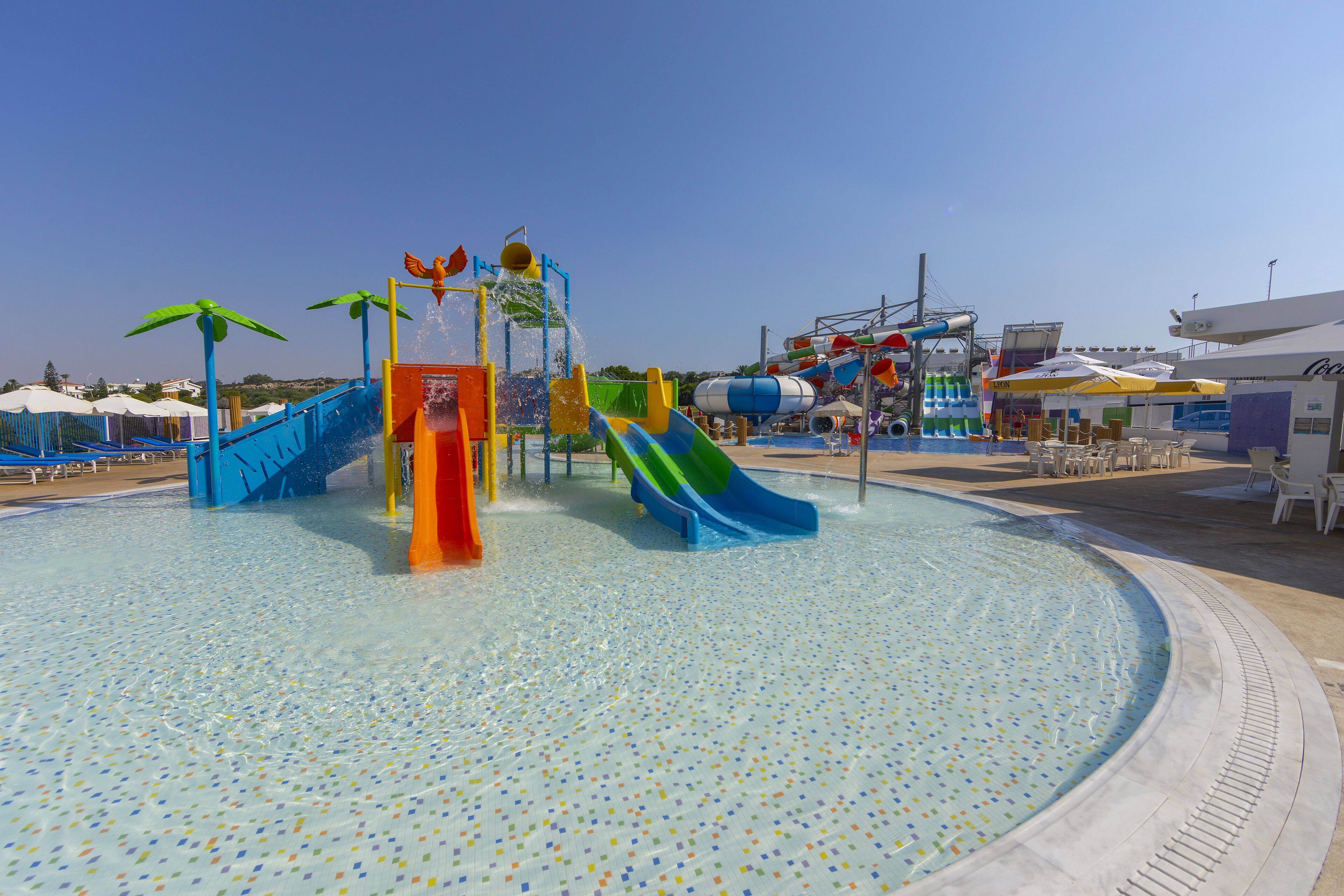 A water park with multiple slides and a pool.