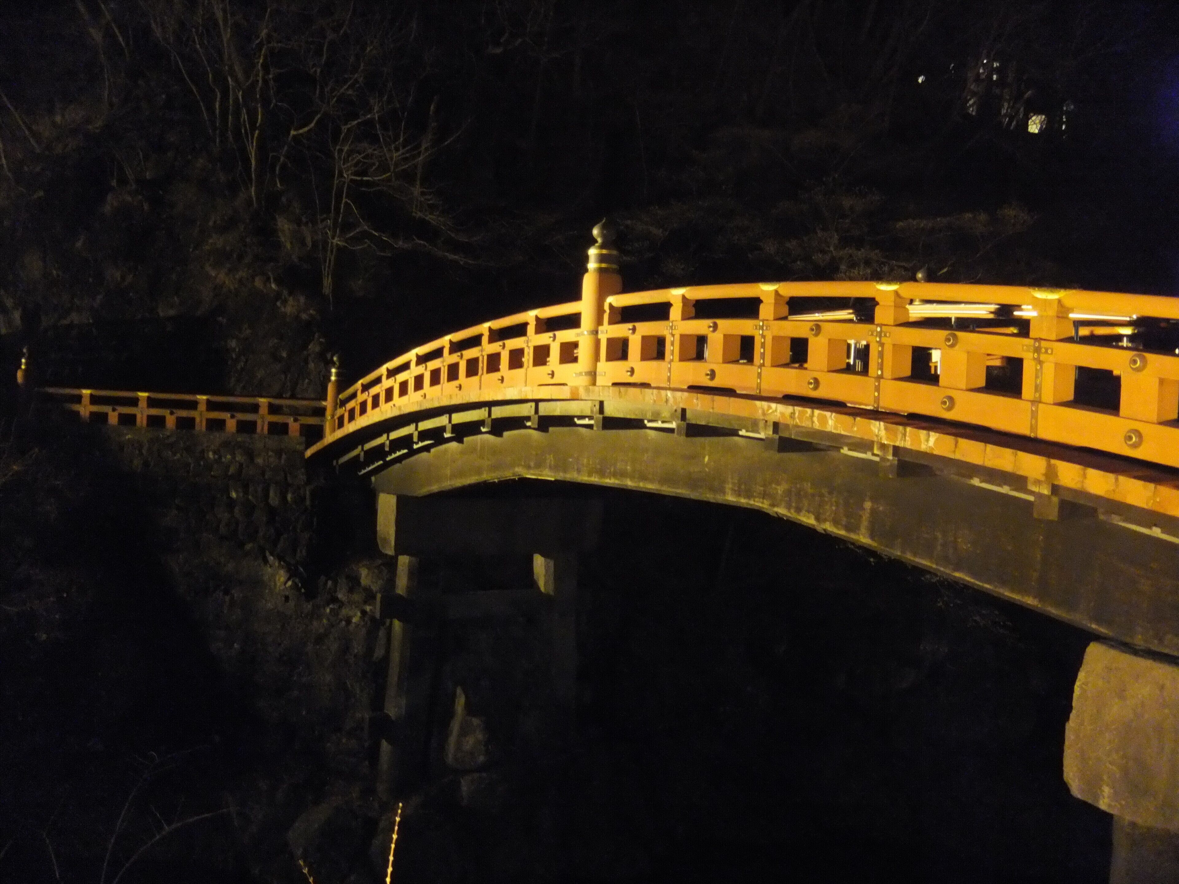 A bridge with a railing and a lamp post.