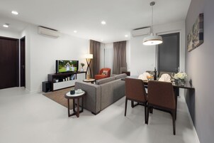 Deluxe Room, 2 Bedrooms, City View | Living area | LCD TV, fireplace, DVD player