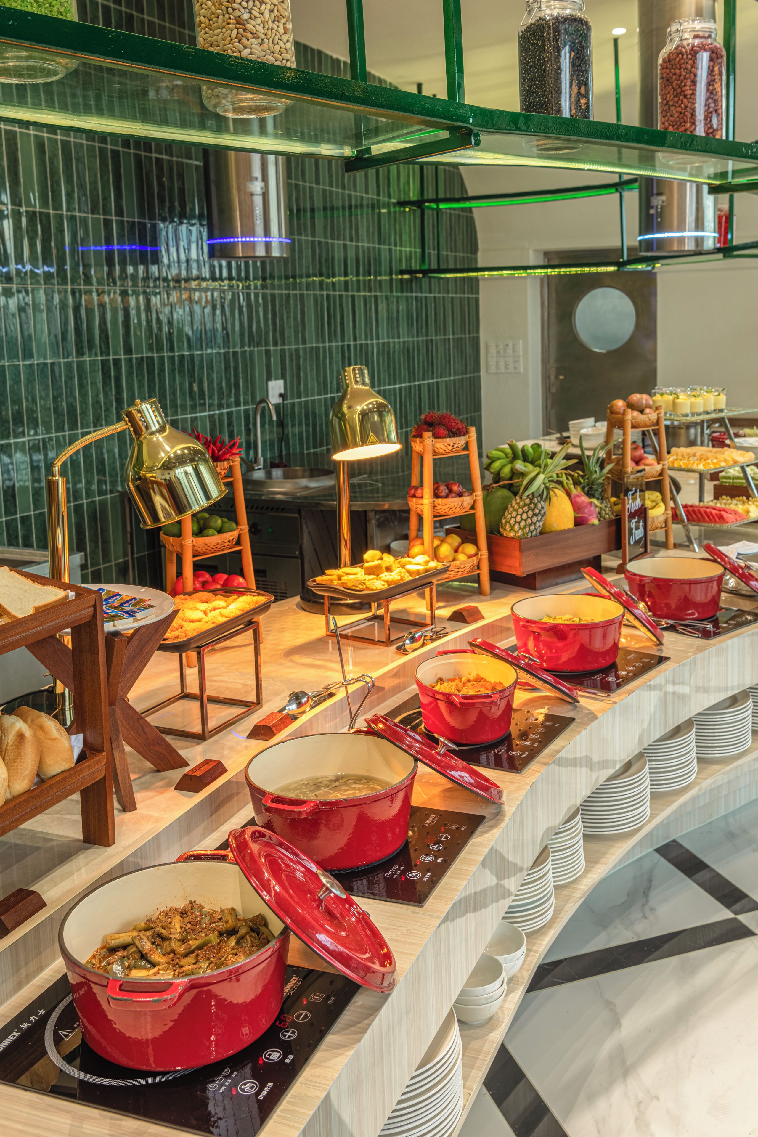 A buffet setup with various food items and cooking stations.
