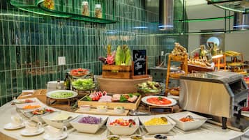 A buffet spread with various food items and a salad bar.