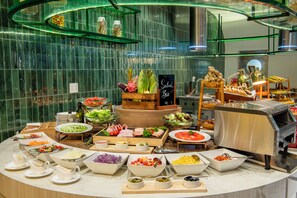 A buffet spread with various food items and a salad bar. - Somerset Central TD Hai Phong City (Hai Phong)