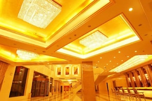 A spacious lobby with a grand chandelier, a staircase, and a reception desk. - Manhattan International Hotel (Huaibei)