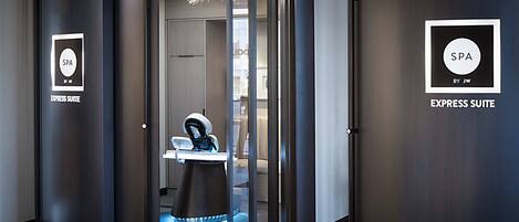 A modern spa suite with a dental chair, a sign indicating the suite name, and a door leading to the suite.