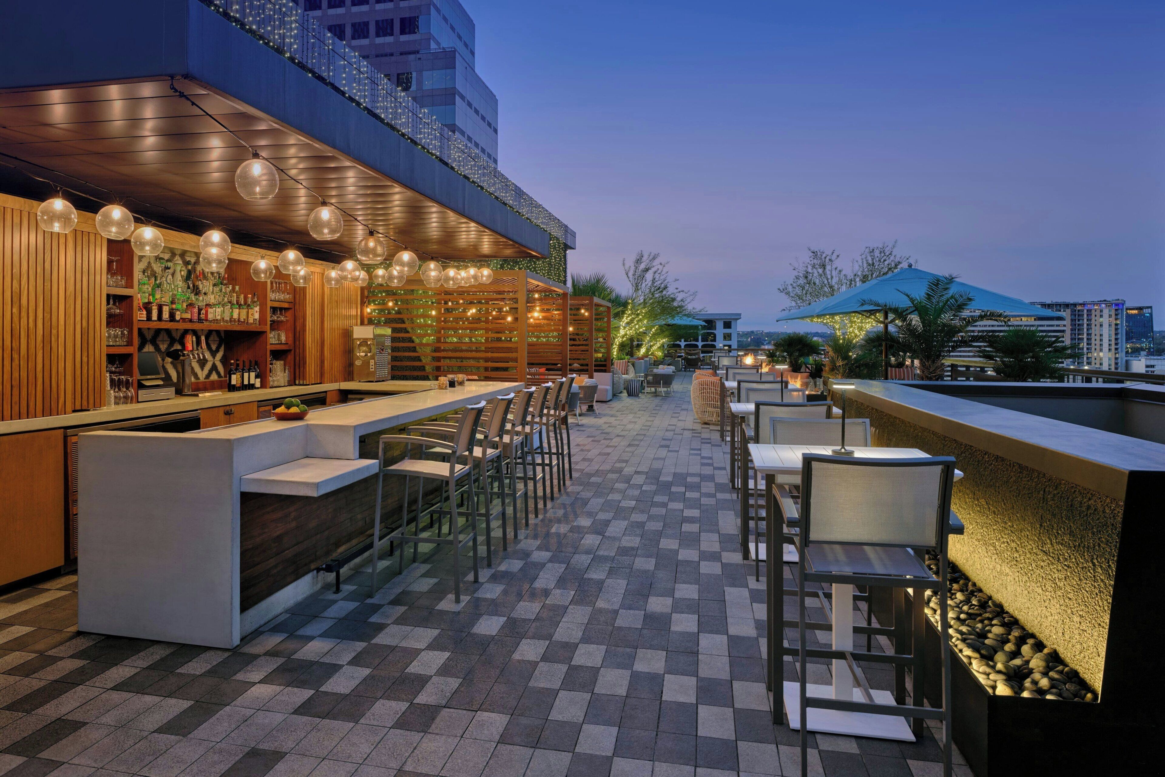 An outdoor bar area with a checkered floor, bar counter, and seating.