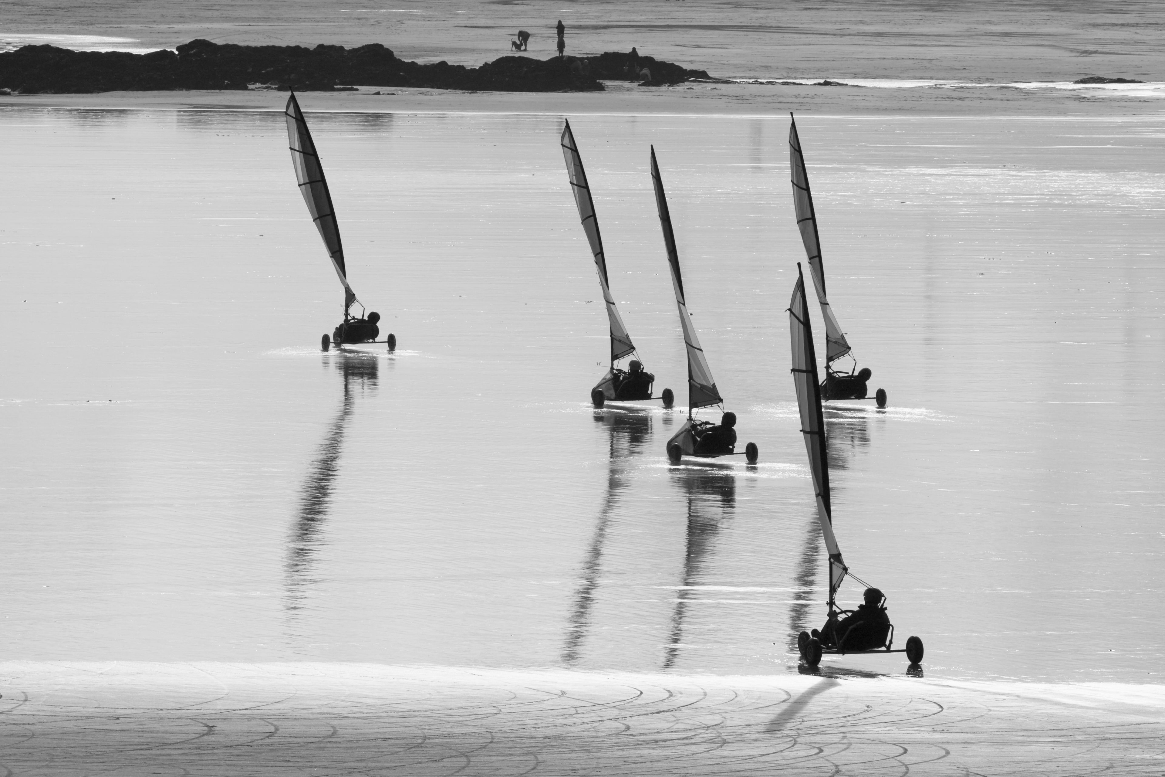 A beach with several sailboats.