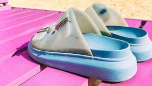 A pair of blue sandals on a pink wooden bench. - The Boardwalk Village (Negril)