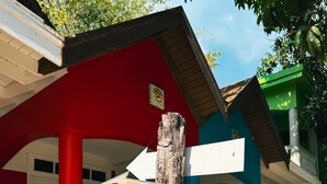 A wooden signpost with directional arrows pointing to 'Desert Rose', 'Anthurium', and 'Lignum Vitae'. - The Boardwalk Village (Negril)